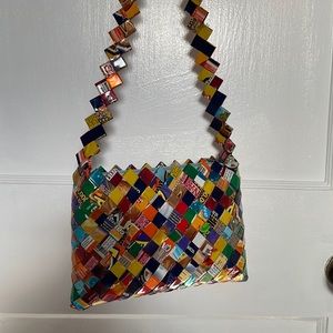 Small, wrapper handbag, NWOT. Never used. Easily holds phone, wallet etc.